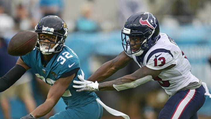 Jacksonville Jaguars cornerback Tyson Campbell (32) can't come up with an interception against Houston Texans wide receiver Brandin Cooks (13) during the fourth quarter Sunday, Dec. 2021 at TIAA Bank Field in Jacksonville. The Jaguars hosted the Texans during a regular season NFL game. Houston defeated Jacksonville 30-16. [Corey Perrine/Florida Times-Union]

Jki 121921 Jagstexans 23 1