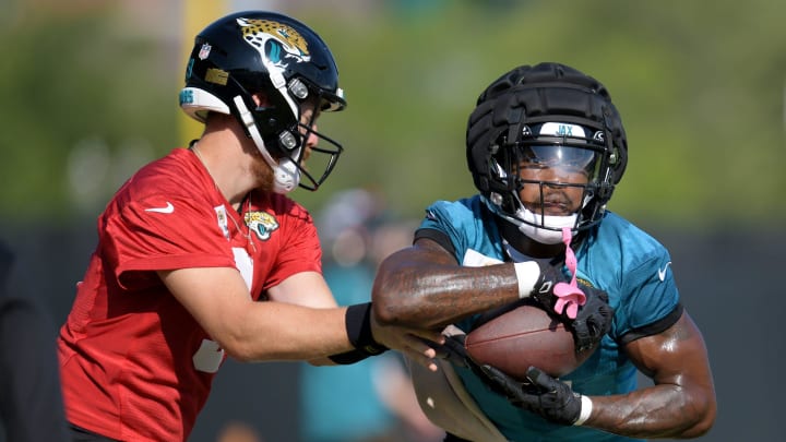 Jacksonville Jaguars quarterback C.J. Beathard (3) hands off to running back Tank Bigsby (4) during drills on the fifth day of the NFL football training camp practice session Monday, July 29, 2024 at EverBank Stadium's Miller Electric Center in Jacksonville, Fla.. [Bob Self/Florida Times-Union]