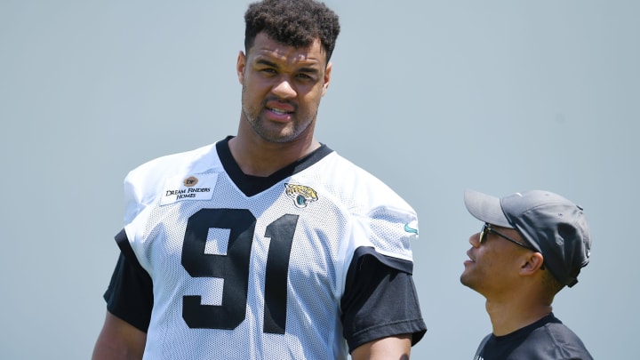 Jaguars director of football communications Dylan Morton talks with Jacksonville Jaguars defensive tackle Arik Armstead (91) at the end of the organized team activity session Monday, June 3, 2024 at EverBank Stadium's Miller Electric Center in Jacksonville, Fla.