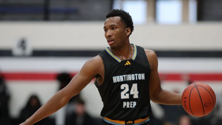 Huntington Prep guard Darryn Peterson takes the ball up the court during the first half at Canton Memorial Field House, Saturday, Feb. 17, 2024.