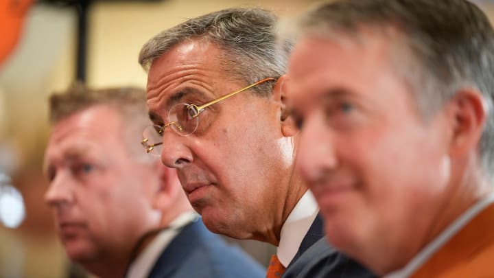 University of Texas Athletic Director Chris Del Conte, middle, and President Jay Hartzell, right, listen during the introductory news conference of baseball coach Jim Schlossnagle, left, at the Frank Denius Family University Hall of Fame Wednesday June 26, 2024.