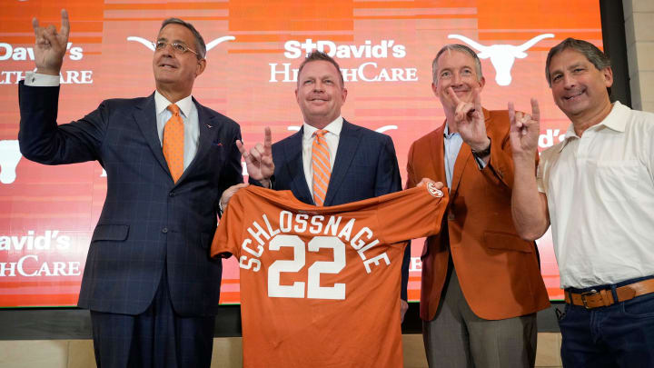 University of Texas baseball coach Jim Schlossnagle, second from left, is joined by UT Athletic Director Chris Del Conte, left to right, President Jay Hartzell and Chairman of the Board of Regents Kevin Eltife at his introductory news conference at the Frank Denius Family University Hall of Fame Wednesday June 26, 2024.