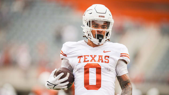 April 20, 2024; Austin, Texas, USA: Texas White team wide receiver DeAndre Moore Jr. (0) runs the ball in for a touchdown in the first quarter of the Longhorns' spring Orange and White game at Darrell K Royal Texas Memorial Stadium. Mandatory Credit: Sara Diggins-USA Today Sports via American Statesman