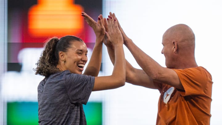 Texas Volleyball outside hitter Madisen Skinner and Head Coach Jerritt Elliott celebrate throwing the ceremonial first pitches ahead of the Longhorns' game against the Texas A&M Aggies at the UFCU Disch-Falk Field in Austin, Tuesday, March 5, 2024.