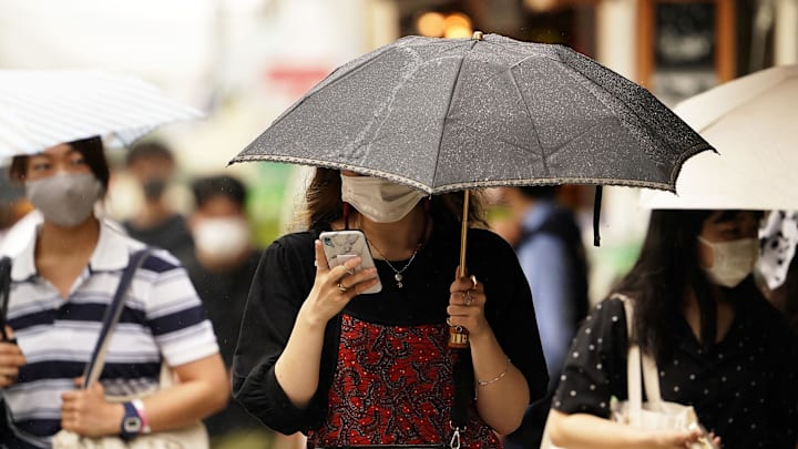 Aug 2, 2021; Enoshima, Japan; Tourists takes cover from the rain on Enoshima Island during the Tokyo 2020 Olympic Summer Games near Enoshima Yacht Harbour. Mandatory Credit: Rob Schumacher-Imagn Images Aug 2, 2021; Enoshima, Japan; Tourists takes cover from the rain on Enoshima Island during the Tokyo 2020 Olympic Summer Games near Enoshima Yacht Harbour. Mandatory Credit: Rob Schumacher-Imagn Images