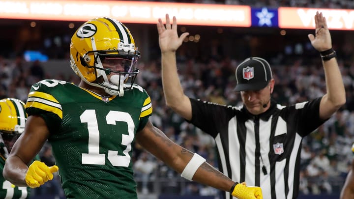 Green Bay Packers wide receiver Dontayvion Wicks (13) celebrates after catching a touchdown pass vs. the Dallas Cowboys.
