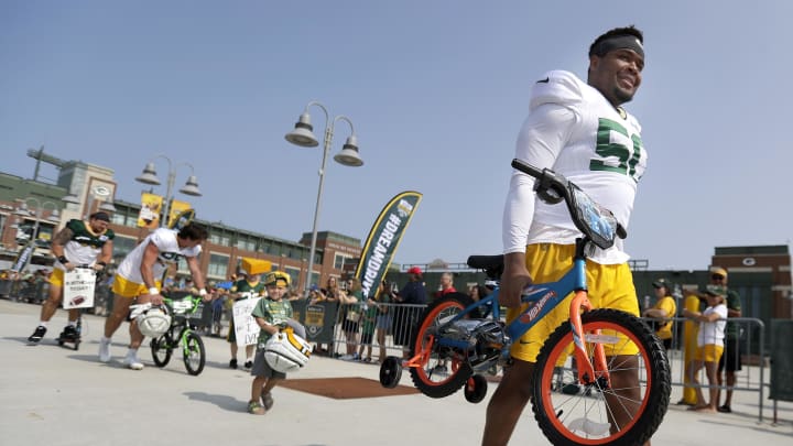 Green Bay Packers offensive lineman Zach Tom takes a bike to practice at training camp last year.