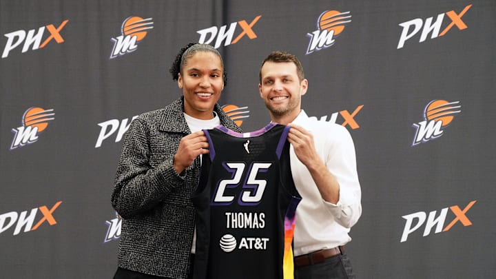New Phoenix Mercury forward Alyssa Thomas poses with general manager Nick U'Ren at a news conference at the Phoenix Mercury's practice facility on Feb. 25, 2025.