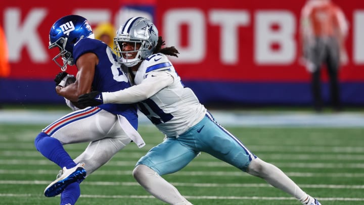 Sep 10, 2023; East Rutherford, New Jersey, USA; Dallas Cowboys cornerback Stephon Gilmore (21) tackles New York Giants wide receiver Darius Slayton (86) during the second half at MetLife Stadium. Mandatory Credit: Ed Mulholland-USA TODAY Sports