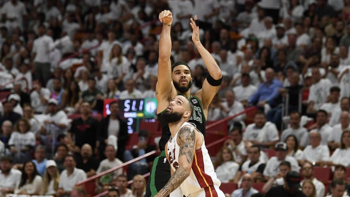 Apr 29, 2024; Miami, Florida, USA; Boston Celtics forward Jayson Tatum (0) takes a 3-point shot over Miami Heat's Caleb Martin - Michael Laughlin/USA TODAY Sports