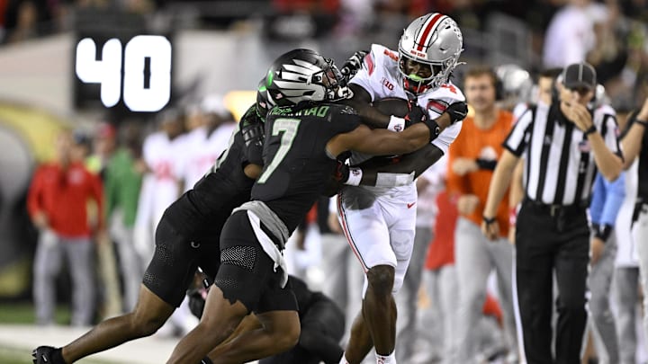 Ohio State Buckeyes wide receiver Jeremiah Smith (4) catches a pass during the second half against Oregon Ducks defensive back Jabbar Muhammad (7) at Autzen Stadium. Ohio State Buckeyes wide receiver Jeremiah Smith (4) catches a pass during the second half against Oregon Ducks defensive back Jabbar Muhammad (7) at Autzen Stadium.