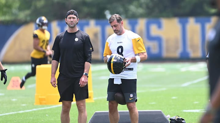 Pittsburgh Steelers quarterback Aaron Rodgers puts on his helmet during minicamp at their South Side facility. Pittsburgh Steelers quarterback Aaron Rodgers puts on his helmet during minicamp at their South Side facility.