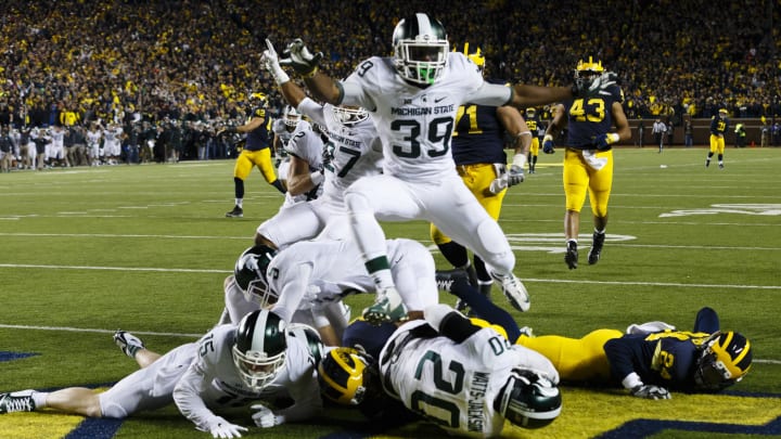 Oct 17, 2015; Ann Arbor, MI, USA; Michigan State Spartans defensive back Jalen Watts-Jackson (20) dives into the end zone for a game winning touchdown as the clock runs out in the fourth quarter against the Michigan Wolverines at Michigan Stadium. Michigan State 27-23. Mandatory Credit: Rick Osentoski-USA TODAY Sports