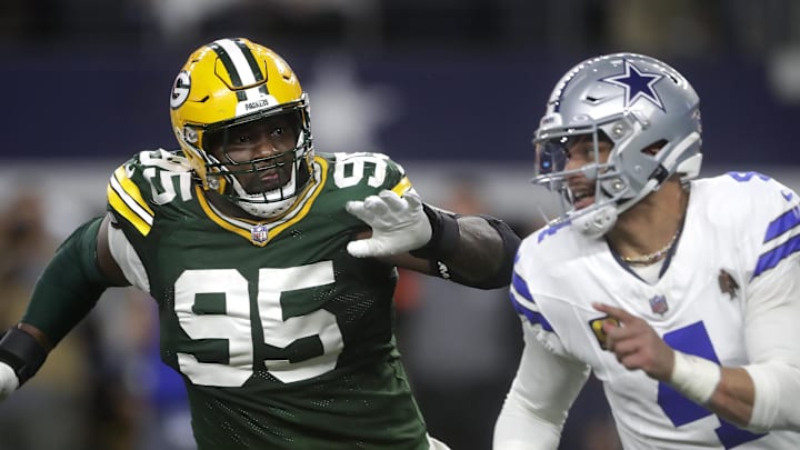 Green Bay Packers defensive tackle Devonte Wyatt (95) rushes Dallas Cowboys quarterback Dak Prescott (4) 