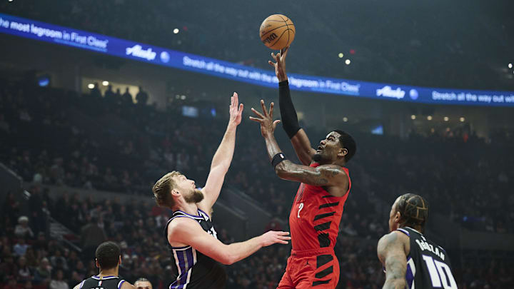 Portland Trail Blazers center Deandre Ayton shoots a jump shot the ball during the first half against Sacramento Kings forward Domantas Sabonis at Moda Center. 