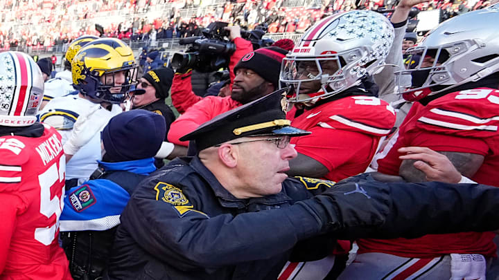 University of Michigan and Ohio State Police intervene as Michigan Wolverines and Ohio State Buckeyes fight following the NCAA football game at Ohio Stadium. University of Michigan and Ohio State Police intervene as Michigan Wolverines and Ohio State Buckeyes fight following the NCAA football game at Ohio Stadium.