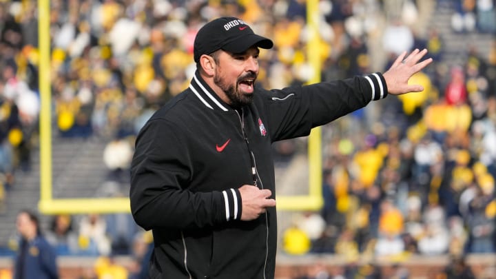 Ohio State coach Ryan Day leads his team in warmups prior to their game against Michigan at Michigan Stadium.