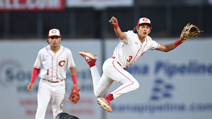 Corona's Billy Carlson leaps over a baserunner in the 2024 Southern Section Division 1 title game | Photo: Heston Quan