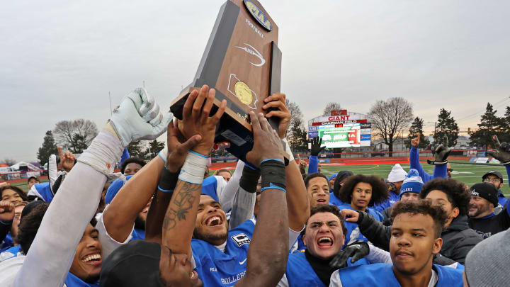 Steelton-Highspire players hoist the 2023 PIAA Class 1A state championship trophy after defeating Fort Cherry 42-8