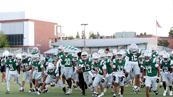 De La Salle players rush the field before the kick off against visiting Grant Union.