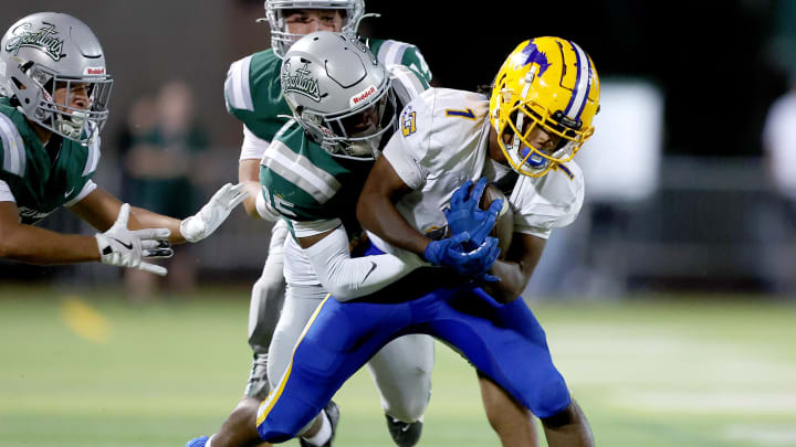 A De La Salle defender tackles Grant's Truman Broadnax from behind during the Spartans' 42-14 opening-week win over Grant. De La Salle moved up from No. 9 to 6 after the victory, while Grant, previously No. 13, dropped to honorable mention