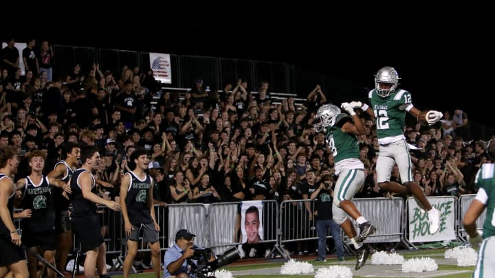 De La Salle defensive back Ant Dean (right) celebrates scoring his first varsity touchdown after ripping the ball out of the hands of QB Luke Alexander and returning it 33 yards for the score in a 42-14 victory Friday night in Concord, Calif. 