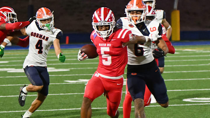 Mater Dei defensive back CJ Lavender Jr. attempts to elude a Bishop Gorman player after making an interception.