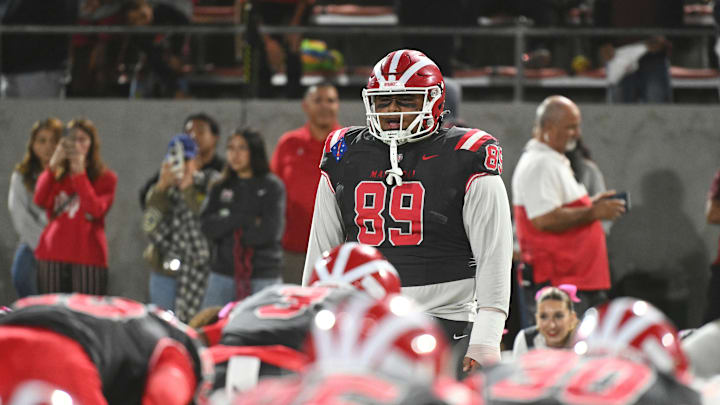Mater Dei DL Semi Taulanga leads the Monarchs in pregame exercises before the Monarchs' 59-14 win over St. John Bosco at Santa Ana Stadium on Oct. 25, 2024 