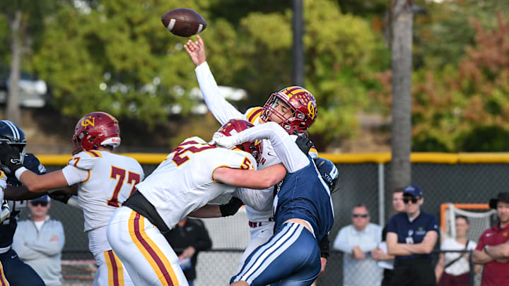 Marin Catholic's defense pressured Cardinal Newman freshman quarterback Tino Retamoza all day during a 13-3 home win to clinch a tie of the initial Redwood Empire-Adobe league crown on Nov. 2.  