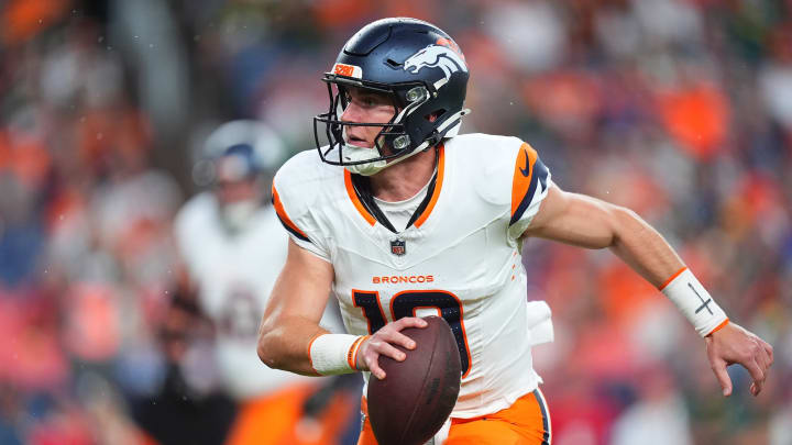 Aug 18, 2024; Denver, Colorado, USA; Denver Broncos quarterback Bo Nix (10) scrambles with the ball in the first quarter against the Green Bay Packers at Empower Field at Mile High. 