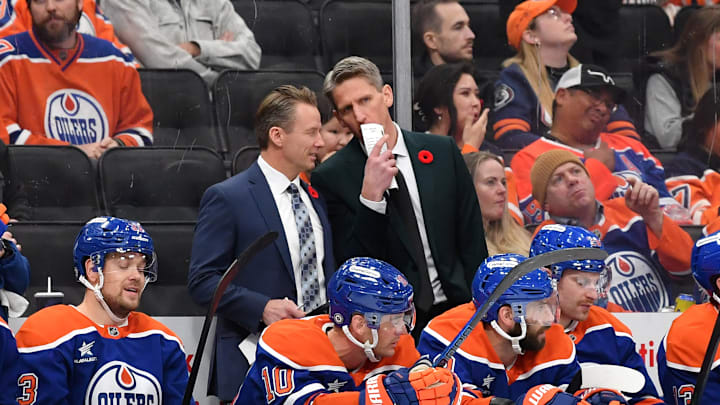 Edmonton Oilers assistant Glen Gulutzan and head coach Kris Knoblauch talk on the bench. Edmonton Oilers assistant Glen Gulutzan and head coach Kris Knoblauch talk on the bench.