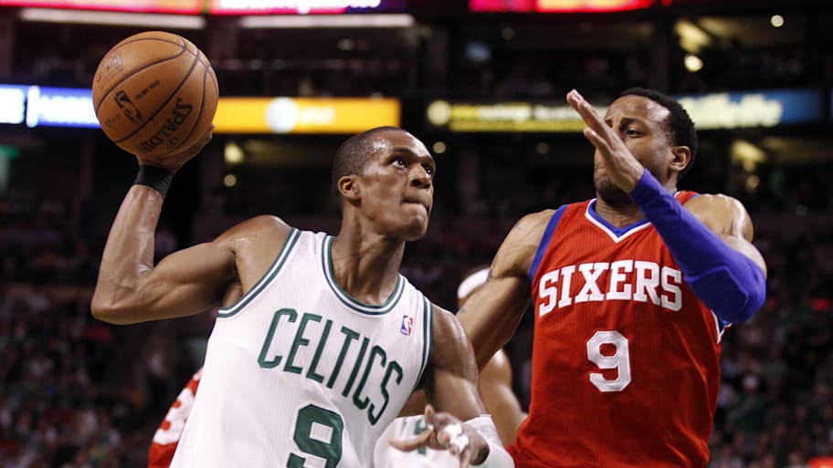 Celtics point guard Rajon Rondo drives to the basket while guarded by 76ers small forward Andre Iguodala.
