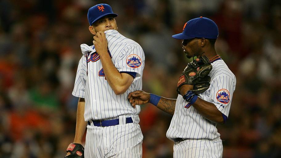 Mets pitcher Oliver Perez (left) is consoled by teammate Jose Reyes on Sept. 28, 2007.