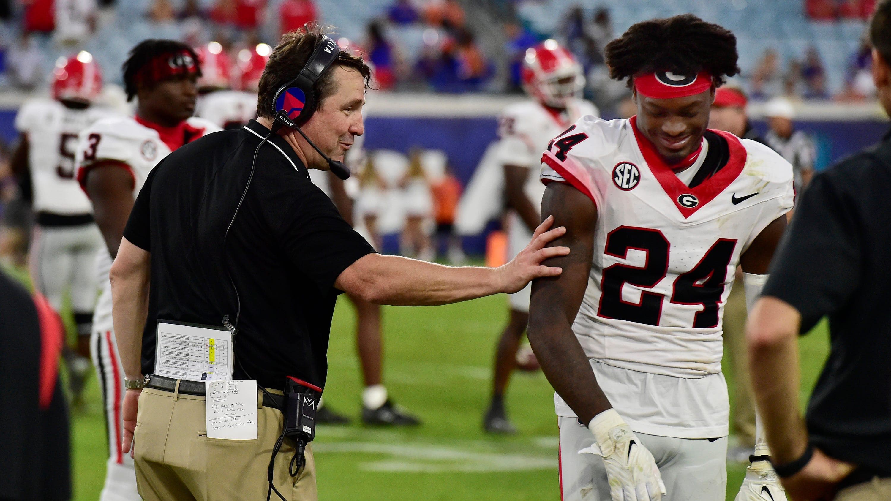 Georgia Bulldogs co-defensive coordinator and former Gator head coach Will Muschamp shares a smile