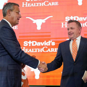 University of Texas baseball coach Jim Schlossnagle, right, is introduced by Athletic Director Chris Del Conte at his introductory news conference at the Frank Denius Family University Hall of Fame Wednesday June 26, 2024.