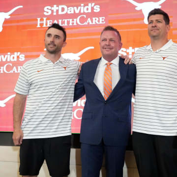 University of Texas baseball coach Jim Schlossnagle, second from left, poses for photos with his assistant coaches, left to right, Michael Earley, Nolan Cain, Max Weinerat his introductory news conference at the Frank Denius Family University Hall of Fame Wednesday June 26, 2024.