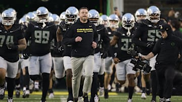 Nov 30, 2024; Eugene, Oregon, USA; Oregon Ducks head coach Dan Lanning runs out with the team before a game against the Washington Huskies at Autzen Stadium