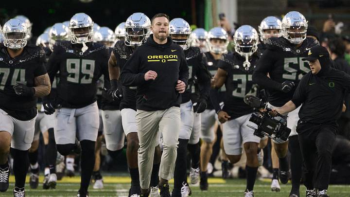 Nov 30, 2024; Eugene, Oregon, USA; Oregon Ducks head coach Dan Lanning runs out with the team before a game against the Washington Huskies at Autzen Stadium