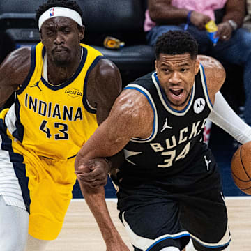 Nov 3, 2025; Indianapolis, Indiana, USA; Milwaukee Bucks forward Giannis Antetokounmpo (34) dribbles against Indiana Pacers forward Pascal Siakam (43) in the first half at Gainbridge Fieldhouse. Mandatory Credit: Trevor Ruszkowski-Imagn Images