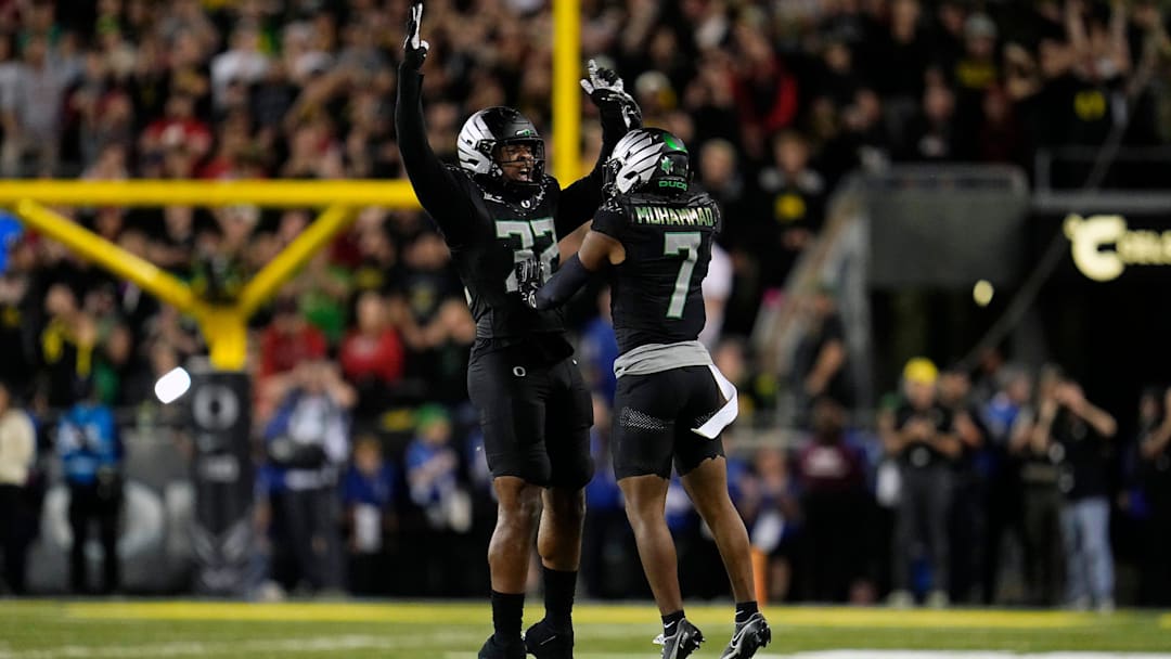 Oct 12, 2024; Eugene, Oregon, USA; Oregon Ducks linebacker Emar'rion Winston (32) and Oregon Ducks defensive back Jabbar Muhammad (7) celebrate after stopping Ohio State Buckeyes in the second half during the NCAA football game at Autzen Stadium.