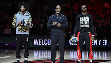 Feb 15, 2024; Portland, Oregon, USA; From left, Portland Trail Blazers guard Shaedon Sharpe (17), head coach Chauncey Billups, and guard Scoot Henderson (00) are recognized for being selected to take part int the NBA All-Star weekend break before a game against the Minnesota Timberwolves at Moda Center. Mandatory Credit: Troy Wayrynen-Imagn Images