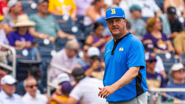 Jun 16, 2025; Omaha, Neb, USA; UCLA Bruins head coach John Savage walks off the field before the game against the LSU Tigers at Charles Schwab Field. Mandatory Credit: Dylan Widger-Imagn Images