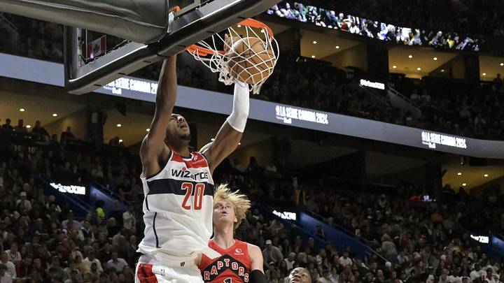 Oct 6, 2024; Montreal, Quebec, CAN; Washington Wizards power forward Alex Sarr (20) dunks over Toronto Raptors guard Gradey Dick (1) during the second quarter at the Bell Centre. Mandatory Credit: Eric Bolte-Imagn Images