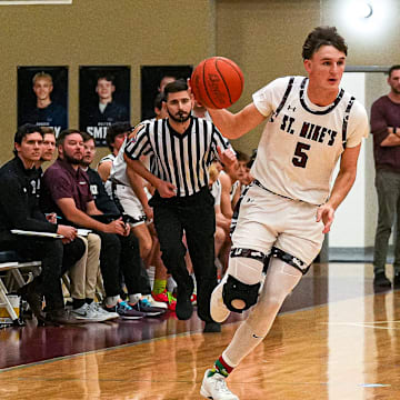 St. Michael's guard Bo Ogden (5) dribbles the ball towards the LASA basket during the game at St. Michael's Athletic Center on Friday, Dec. 20, 2024 in Austin.