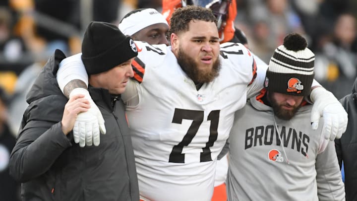 Jan 8, 2023; Pittsburgh, Pennsylvania, USA;  Injured Cleveland Browns tackle Jedrick Wills Jr. (71) is helped off the field in a game against the Pittsburgh Steelers during the fourth quarter at Acrisure Stadium.