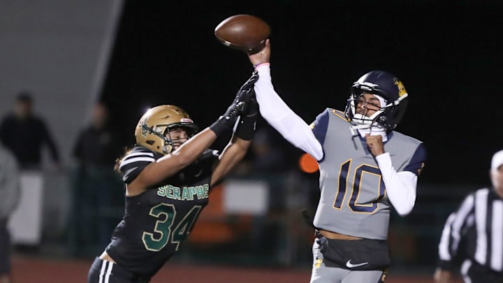 Warren quarterback Madden Iamaleava is under pressure by St. Bonaventure's Jacob Moraga as he fires a pass during the first quarter of the Seraphs' 24-21 win in the CIF-SS Division 3 championship game on Saturday, Nov. 25, 2023, at Ventura High's Larrabee Stadium.