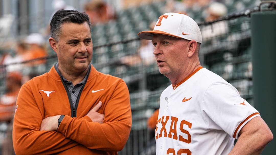 Texas Basketball coach Sean Miller chats with Texas Baseball coach Jim Schlossnagle as the Longhorns prepare to take on the Auburn Tigers in the first game of a three-game series on Thursday night at UFCU Disch-Falk Field in Austin, April 17, 2025.