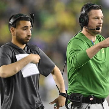 Sep 7, 2024; Eugene, Oregon, USA; Oregon Ducks head coach Dan Lanning signals his defense during the first half against the Boise State Broncos at Autzen Stadium. Mandatory Credit: Troy Wayrynen-Imagn Images