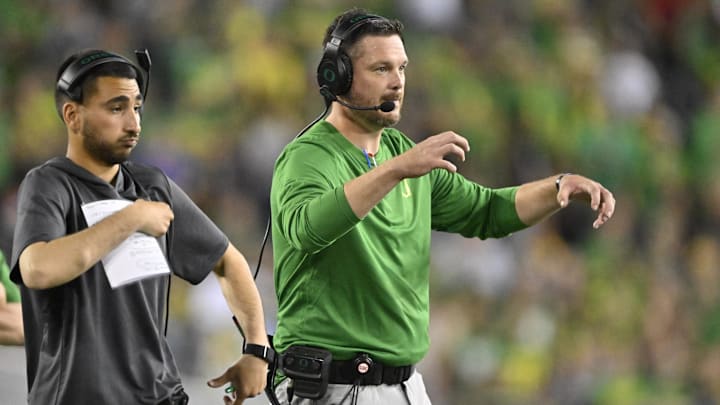 Sep 7, 2024; Eugene, Oregon, USA; Oregon Ducks head coach Dan Lanning signals his defense during the first half against the Boise State Broncos at Autzen Stadium. Mandatory Credit: Troy Wayrynen-Imagn Images