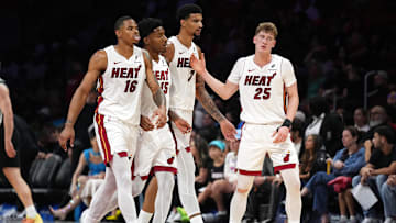 Oct 8, 2025; Miami, Florida, USA;  Miami Heat guard Kasparas Jakucionis (25) is congratulated by forward Keshad Johnson (16), forward Myron Gardner (15) and center Kel'El Ware (7) during a timeout in the second half against the San Antonio Spurs at Kaseya Center. Mandatory Credit: Jim Rassol-Imagn Images